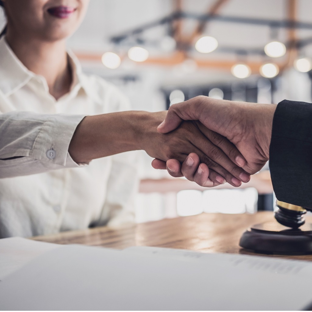 handshake-after-good-cooperation-businesswoman-shaking-hands-with-professional-male-lawyer